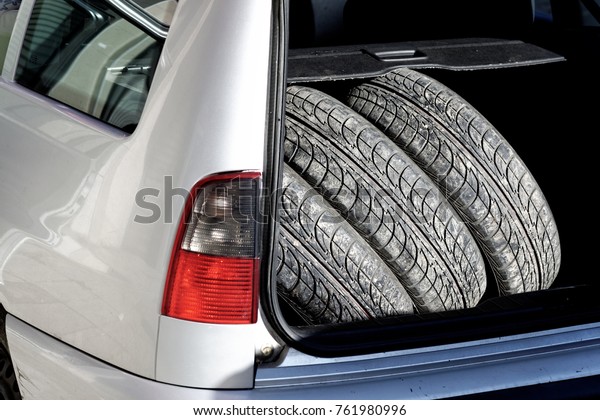 A car boot\
loaded with summer tires. Close\
up.
