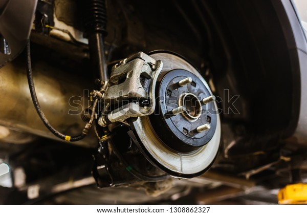 Car brake\
disc repair on a lift, auto brake\
system