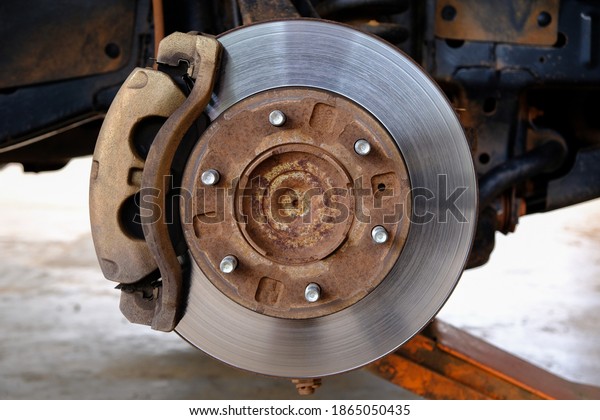 Car brake disc without wheels closeup. brake pad\
of the vehicle for repair