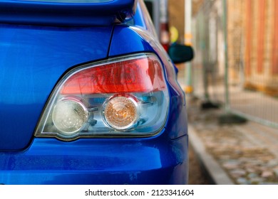 Car Brake Light. Close-up of Rear light or Tail lamp. Sport Blue Car From Behind. Car Parked on the Road.