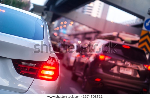 Car brake light and\
traffic concept - LED car brake light on traffic jam hour in\
bangkok, thailand with flare light effect and copy space, use for\
traffic jam content