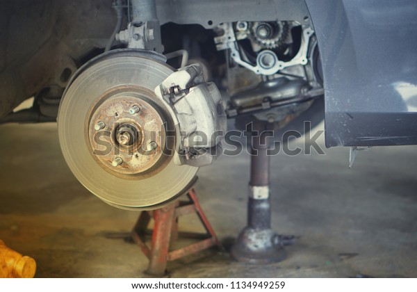 Car brake part at garage,car brake disc without
wheels closeup.Close up.
