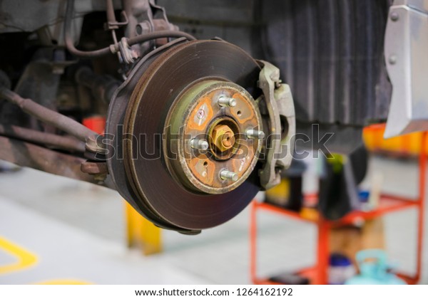 car brake part at garage,car brake disc without\
wheels closeup