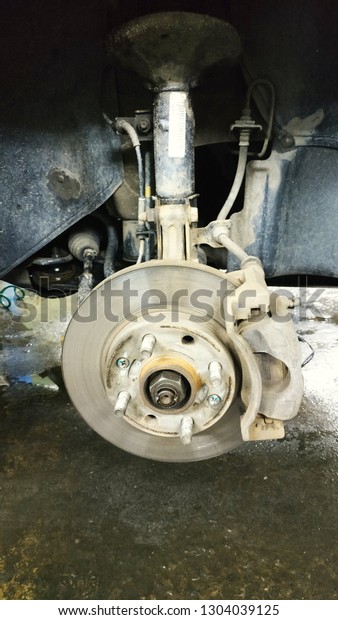 Car brake part at garage,car brake disc without
wheels closeup