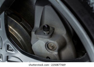 Car brakes bleeder valves. Bleeder bolt on the modern car brake calipers and disc brake rotor. - Shutterstock ID 2250877469
