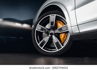 Car braking system. Suv car front wheel brake at the night city street - Shutterstock ID 2002744652