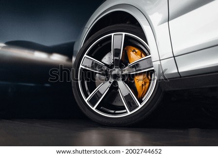 Car braking system. Suv car front wheel brake at the night city street
