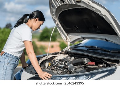 Car breakdown, asia women stands near a broken-down car in the middle of the highway.  - Powered by Shutterstock