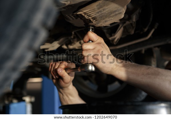 Car breakdown, check condition, inspection,\
engineering, insurance, repair concept. Side profile shot of\
satisfied businessman in classy suit shaking arm of mechanic, near\
his property, silver car