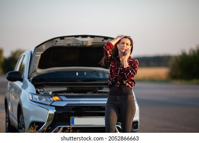 Car breakdown on road. Young desperate woman calling emergency help near broken car on road. Help needed. Car service. - Powered by Shutterstock