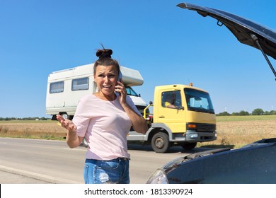 Car Breakdown, Unhappy Woman On The Road With Open Car Hood Talking On The Mobile Phone. Car Repair Service, Transportation, Tow Truck Call