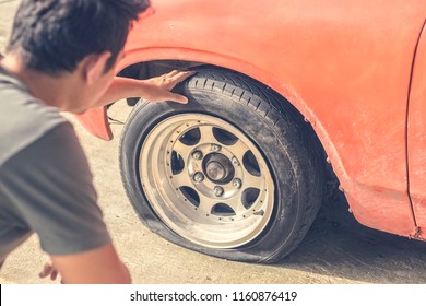 Car Breakdown And Wheel Flat Tire On The Road In The City.