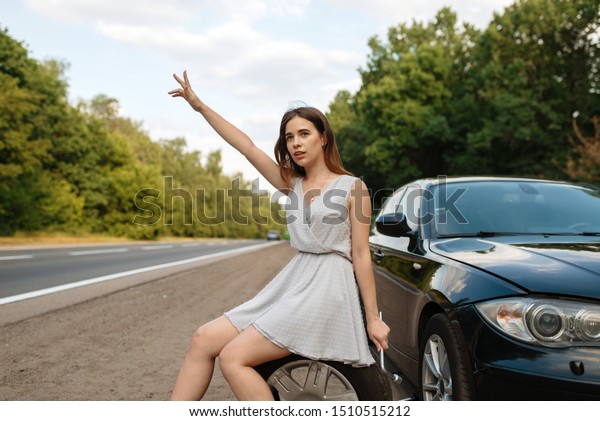 Car breakdown,\
young woman vote on the\
road