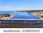 Car bridge across Clyde river in Batesman bay on AUstralian Sapphire coast - aerial landscape view.