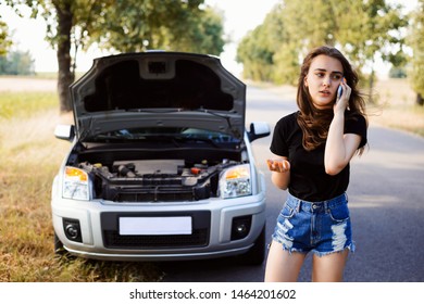 Car Broke By The Wayside Of The Asphalt Road And Young Student Driver Calls The Rescue Team To Help Her And Repair The Car