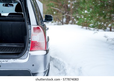 Car Broke Down. Rear View With An Open Trunk, Winter In A Forest