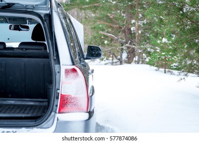 Car Broke Down. Rear View With An Open Trunk, Winter In A Forest