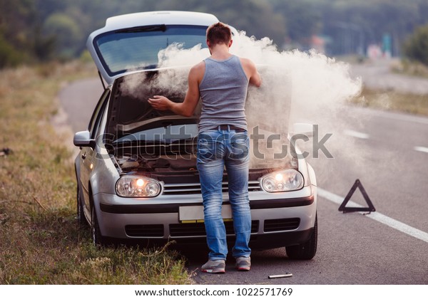The car broke down, smokes from under the
hood, the driver
shocked