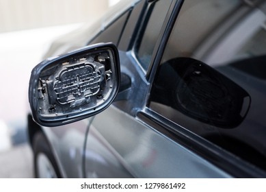 Car with broken rear mirror close up