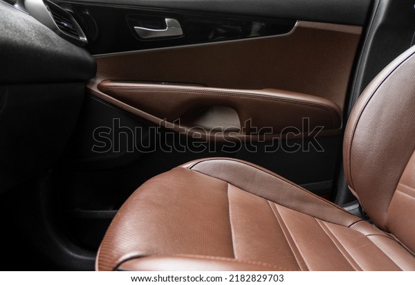 Car brown\
leather interior. Part of brown perforated leather car seat details\
with white stitching. Interior of prestige car. Comfortable\
perforated leather seats. Perforated\
leather.