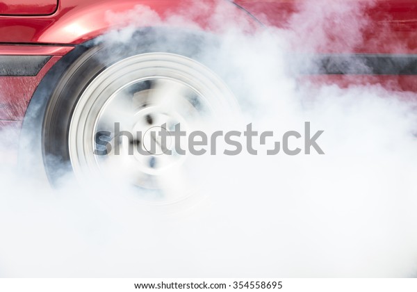 A car burnout at a\
drag racing track