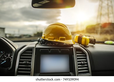 Car For Business Concept. Construction Worker Hard Hat, Safety Glasses And Noise Reduction Ear Muffs On The Pickup Truck Dashboard. Truck Leasing For Business.