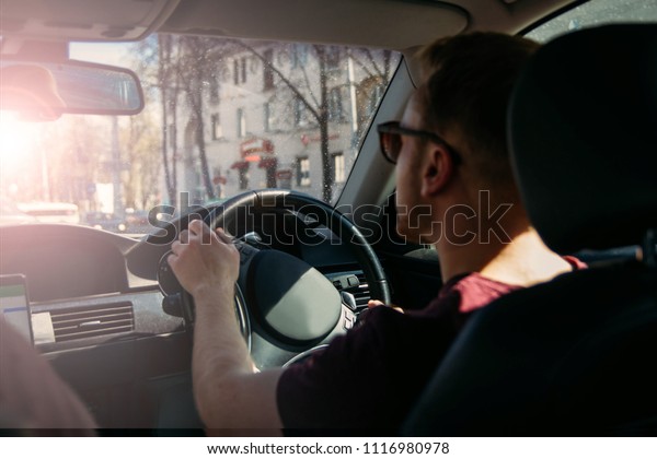 car business driver driving. luxury\
transportation service. steering wheel on the\
right.
