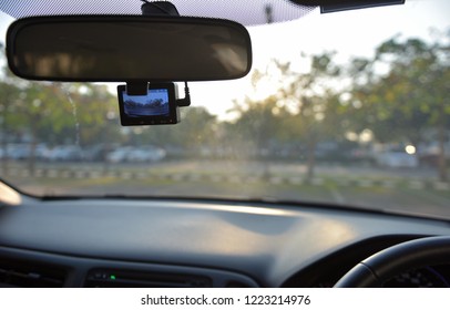 Car camera set ready for recording in front of car while a driver is ready to drive a car off from the parking lot in the morning with a nice weather. - Shutterstock ID 1223214976
