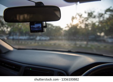 Car camera set ready for recording in front of car while a driver is ready to drive a car off the parking lot in the morning. - Shutterstock ID 1336100882