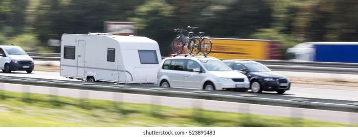 car with a caravan highway speed blur