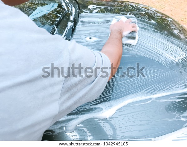 Car Care Business : Using black sponge to wash\
the car with foam bubble.