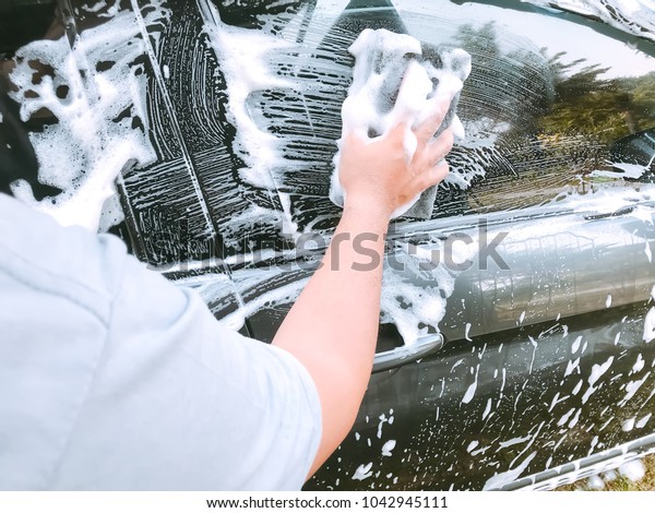 Car Care Business : Using black sponge to wash\
the car with foam bubble.