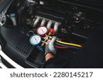Car care maintenance and service, Hand technician auto mechanic using measuring manifold gauge check refrigerant and filling car air conditioner to fix repairing heat conditioning system.