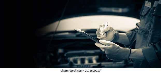 Car care maintenance and servicing, Close-up hand technician auto mechanic checking inspection list after repairing change spare part car engine problem and car insurance service. - Powered by Shutterstock