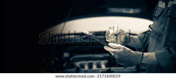 Car care\
maintenance and servicing, Close-up hand technician auto mechanic\
checking inspection list after repairing change spare part car\
engine problem and car insurance\
service.