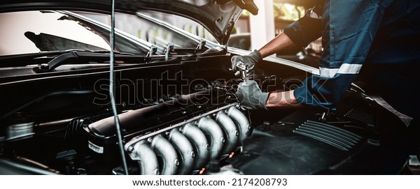 Car care\
maintenance and servicing, Close-up hand technician auto mechanic\
using the wrench to repairing change spare part car engine problem\
and car insurance service\
support.