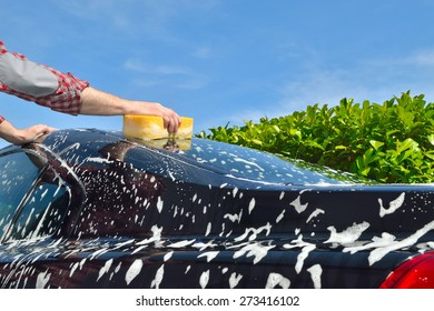 Car Care - Man Washing A Car By Hand Using A Sponge