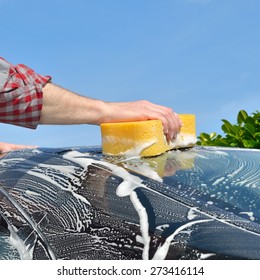 Car Care - Man Washing A Car By Hand Using A Sponge