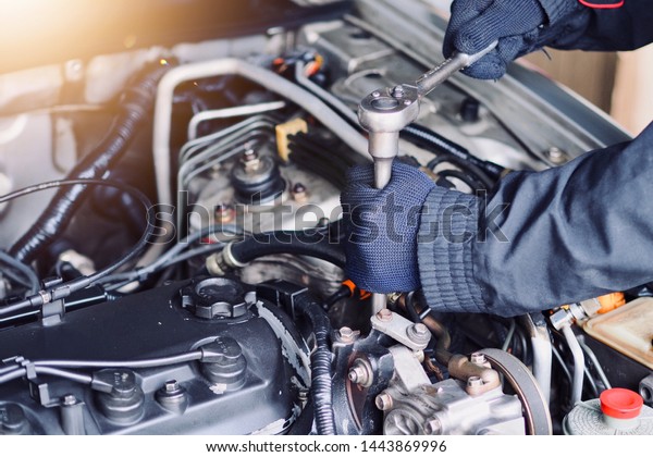 Car care, car mechanic are holding tools for\
repairing cars in their\
hands.