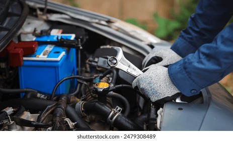 Car care and service A technician is troubleshooting an engine. Spare parts of car engines that have problems and support car insurance services, standard car repair service center concepts. - Powered by Shutterstock