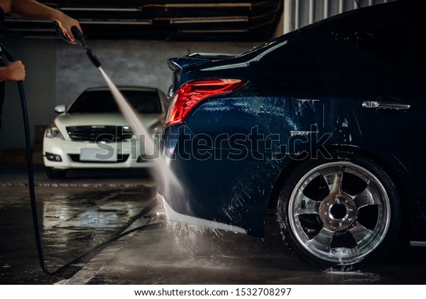 Car care
staff cleaning (clean, wash, polish and wax) the car (Car
detailing) at car care shop in Bangkok
Thailand