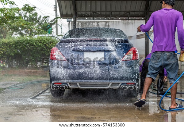 Car care\
staff cleaning the car (Car\
detailing).