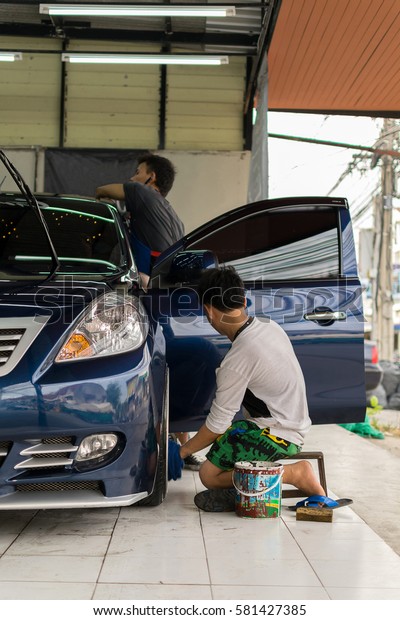 Car care\
staff cleaning the car (Car\
detailing).