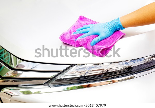 Car care workers cleaning\
the car