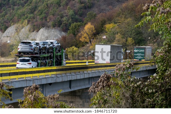 Car carrier. The cars transported are Ford Puma. The\
car carrier crosses a bridge. Cars transporter. Romania, Severin.\
November, 02, 2020