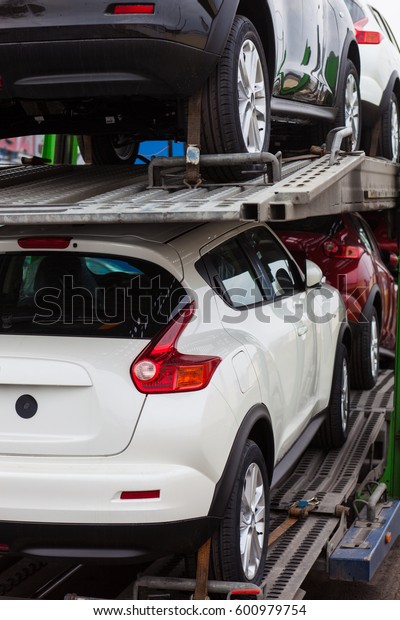Car carrier\
trailer with new cars. Back\
view.