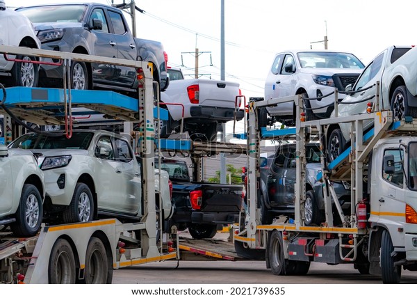 Car carrier trailer transport new car from\
manufacturing factory to dealer. Auto vehicle haul truck delivery.\
Transport logistics in automotive industry. Car carrier trailer\
load new car to shipping.