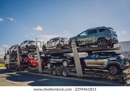 Car carrier trailer transports cars on highway at blue sky background. Stock foto © 