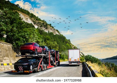 Car Carrier Transporter Truck On Road. Auto Vehicles Hauler On Driveway- Overtaking The Truck. No Logo,brand.