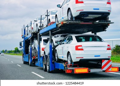 Car Carrier Truck At The Asphalt Road Of Poland. Truck Transporter